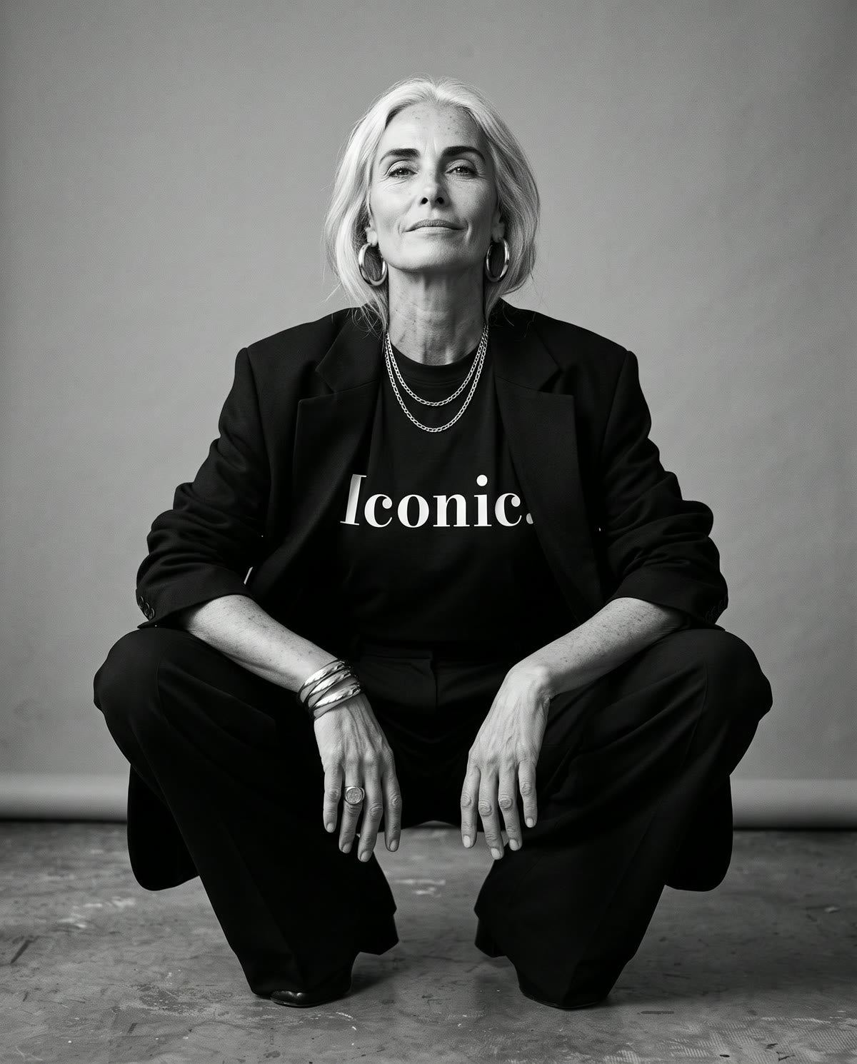 Iconic Tee worn on set, crouched, full length